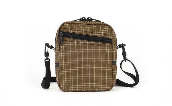 An Everyday Cubelet in Coyote Halcyon (brown with a white grid) with a front zipper.